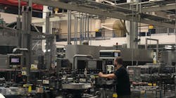 Workers monitor the packaging line at Anheuser-Busch&rsquo;s facility in St. Louis.